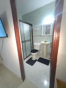 a bathroom with a toilet and a sink at Hotel Montserrat Luxury in Valledupar +15 photos