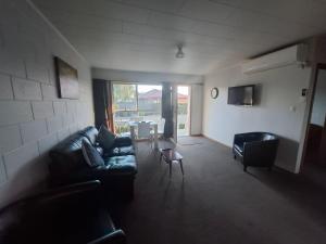 a living room with a couch and a table at Aalton Motel Temuka in Temuka