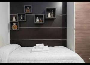 a bedroom with a black wall with a white bed at Meson Cavour in Avigliano