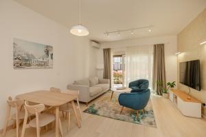 a living room with a table and a couch at River side apartment B3 in Herceg-Novi