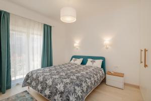 a bedroom with a bed and a window with green curtains at River side apartment B3 in Herceg-Novi +20 photos