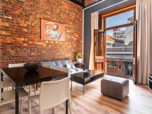 a living room with a brick wall and a table and chairs at Long Street Boutique Hotel in Cape Town