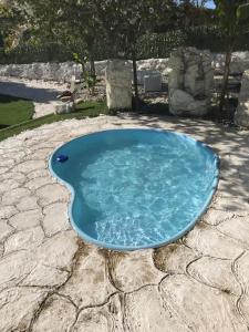 a small pool of blue water on a patio at Marcemar in Borbén