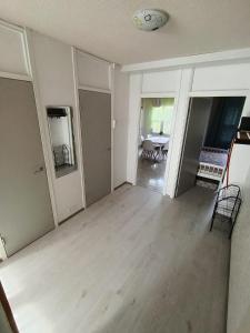 an empty living room with wooden floors and white walls at Kolmio Väinöläntie 6 in Lieksa