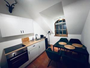 a kitchen with a table and chairs and a sink at Oldenburger Mühle in Oldenburg