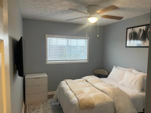 a bedroom with a bed and a ceiling fan at Stylish 3BR Townhouse in Radcliff +2 photos