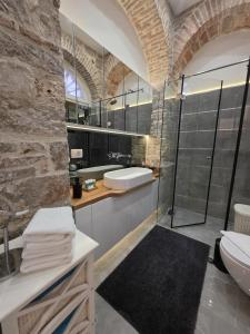 a bathroom with a glass shower and a sink at Dalti Center Apartment in Zadar +15 photos