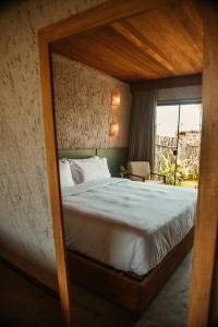 a bedroom with a large bed with a wooden frame at Reserva Mazu in São Miguel dos Milagres +22 photos