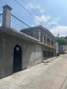 a building with a door and a balcony on it at The best sunrise in Salina Cruz