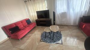 a living room with a red couch and a table at The best sunrise in Salina Cruz