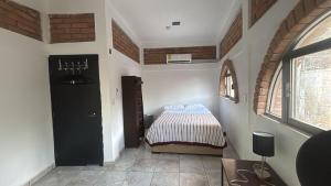 a bedroom with a bed and a black door at The best sunrise in Salina Cruz