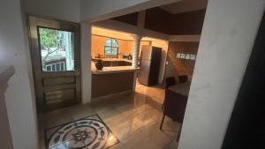 a kitchen with a refrigerator and a table and a window at The best sunrise in Salina Cruz