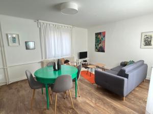a living room with a couch and a table at Au perron avec garage et balcon à Ribeauville in Ribeauvillé +15 photos