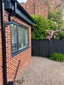 a window on the side of a brick house at The Nest - Worcester in Worcester