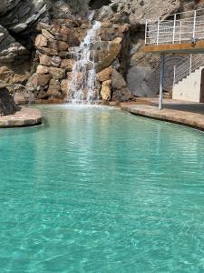 a waterfall in the middle of a pool of water at CapSaSalBegur137 Piscina del Mar, Vista al Patio in Begur