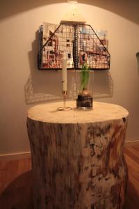 a table made out of a tree stump with a candle on it at Davids Kulle in Ronneby