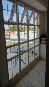 a room with a large window with a view of a courtyard at Departamento centro Gral Roca in General Roca