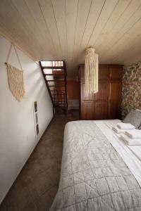 a bedroom with a bed and a staircase in a room at Elia & Petra Villa in Prinos