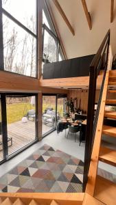 a house with a staircase and a living room at Chill ChaTka Osowiec Las&SPA pod Warszawą in Osowiec