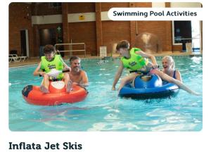 a group of people playing in a swimming pool at The Retreat Camber in Camber