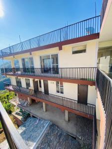 an aerial view of a building with a balcony at Rivervalley View Homestay in Kandāghāt +21 photos