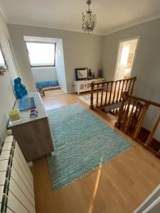 a living room with a rug on the floor at A casa das hortênsias- caminho de Santiago in São Pedro da Torre