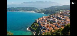 an aerial view of a town on a hill next to the water at La Casina de L'Aspu in Luces