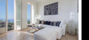 a white living room with a couch and a table at Luxury Penthouse Villa Belle Epoque Monaco GP in Cap d'Ail