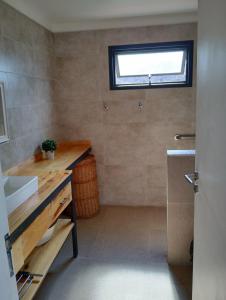 a bathroom with a sink and a window at Cabaña San Charbel in Potrerillos +32 photos