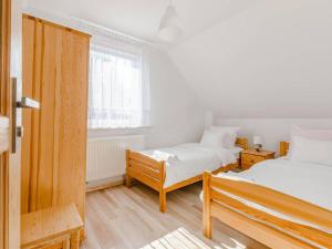 a bedroom with two beds and a window at Ryn - Rybical Resort in Rybical