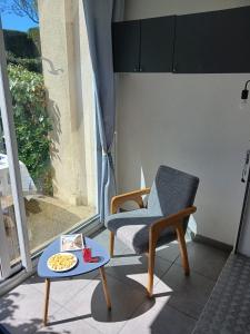 a chair and a table on a balcony at Pointe Saint-Jacques - L'entre deux vagues in Sarzeau +25 photos
