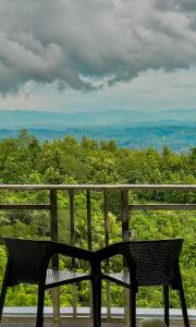 a chair sitting on top of a balcony with a view at Cloudy Inn Resort in Bāndarban +4 photos