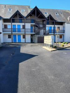 a large building with a parking lot in front of it at Pointe Saint-Jacques - L'entre deux vagues in Sarzeau