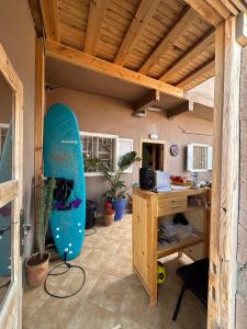 an office with a surfboard in a room at Tildi surf house in Imsouane