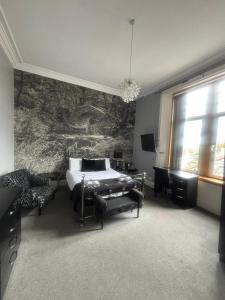 a bedroom with a bed and a wall mural at Ugie House in Keith