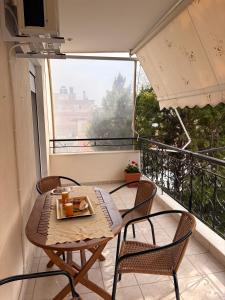 a table and chairs on a balcony with a view at Summer Comfort Apartment in Nea Kallikrateia