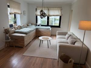 a living room with a couch and a table at WohlfühlWerk L7 in Mechernich +47 photos