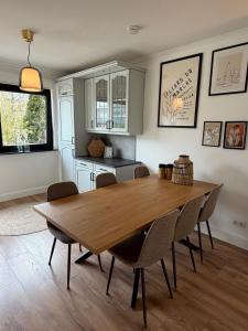 a dining room with a wooden table and chairs at WohlfühlWerk L7 in Mechernich