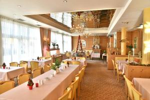 ein Esszimmer mit weißen Tischen und Stühlen in der Unterkunft Hotel Dorotheenhof in Cottbus