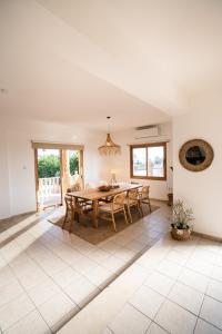 a dining room with a table and chairs at Casa Alba Modern Boho Villa with private Pool near to Sea, Paphos in Peyia