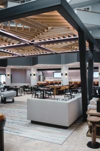 a dining area with tables and chairs in a building at Radisson Hotel Santa Maria in Santa Maria