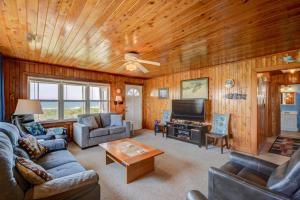 a living room with a couch and a tv at Wave To Cool in Surf City