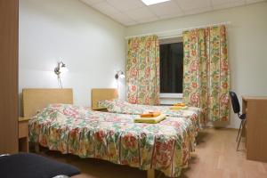 a hospital room with two beds and a window at Posti Hostel in Kärdla