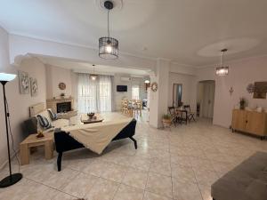 a living room with a couch and a table at Summer Comfort Apartment in Nea Kallikrateia