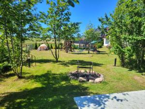 a park with a fire pit and a playground at Domki Oaza Spokoju in Władysławowo