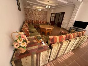 a living room with a couch and a table at Villa Oasis Ain El Turk in Aïn El Turk