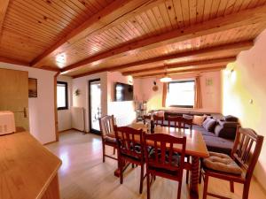 a kitchen and living room with a table and chairs at Chalet Anita Rogla in Zreče