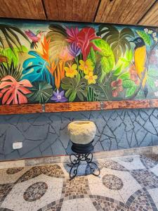 a painting on the wall of a room with a stool at Finca Campestre Villa del Campo in Santa Rosa de Cabal