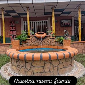 a fountain in the front yard of a house at Finca Campestre Villa del Campo in Santa Rosa de Cabal
