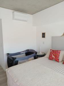a bedroom with a bed and a chair in it at Departamento de mar- UF5-La Reserva Almarena in Costa del Este +80 photos